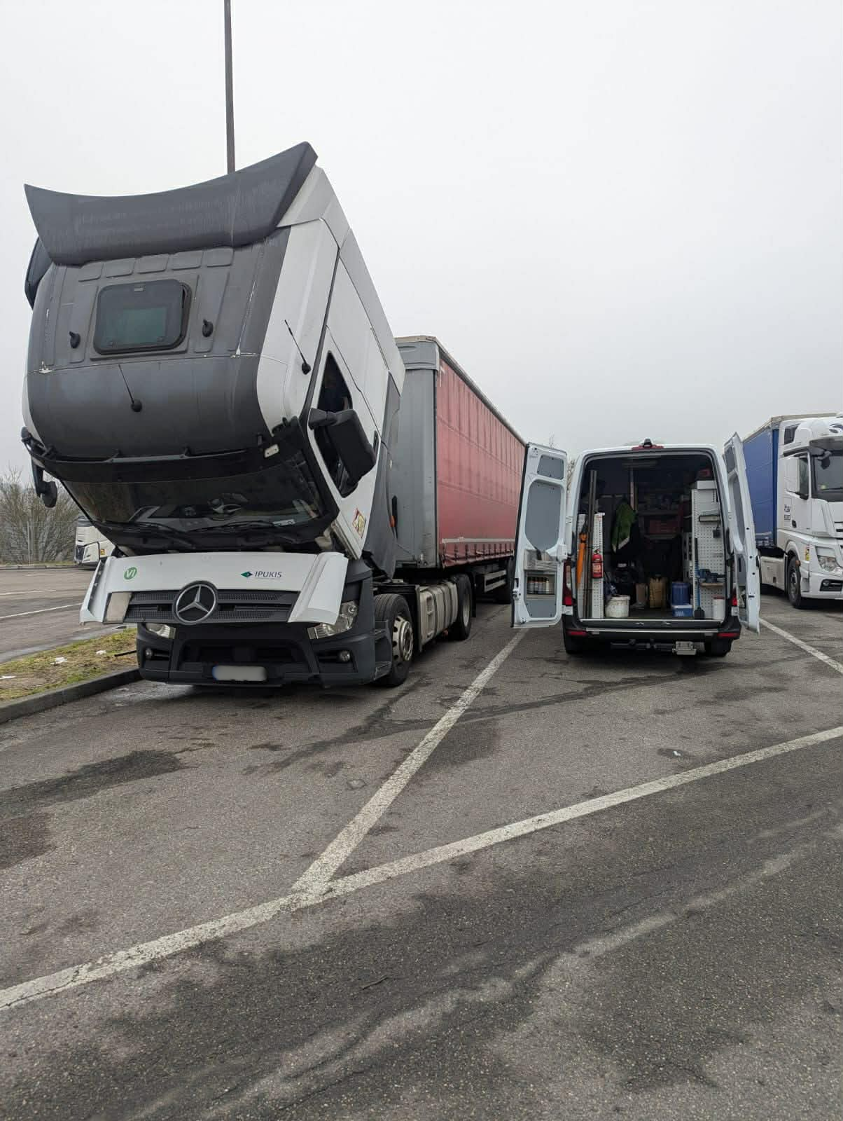 Mercedes truck with cab tilted receiving service